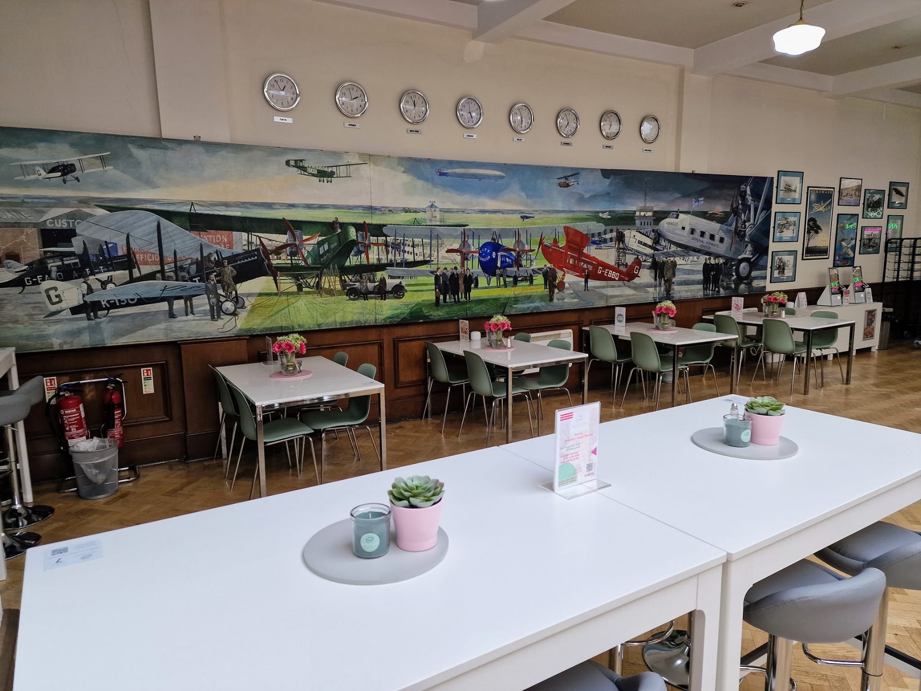 Seating beside the historic aircraft mural inside Airport House